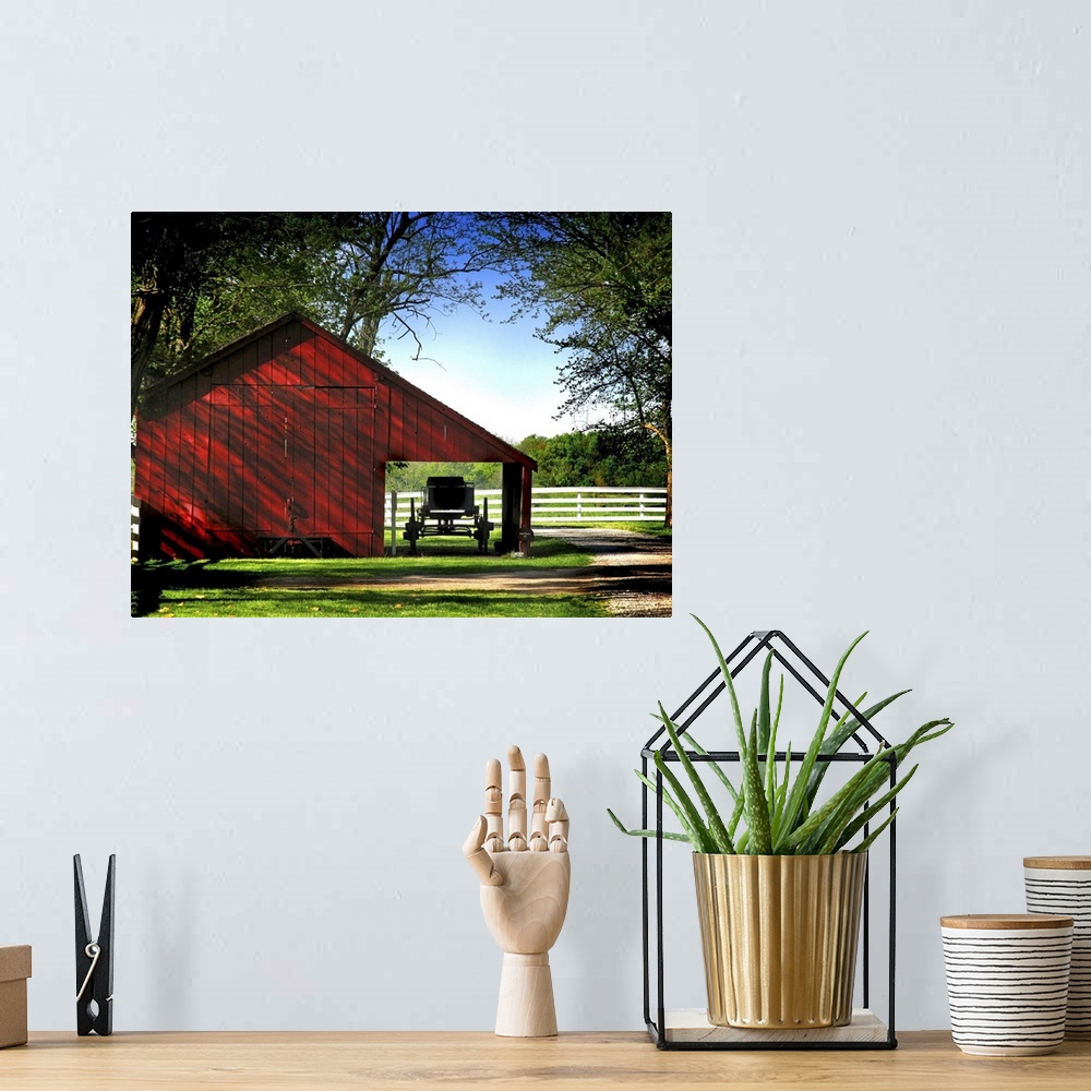 A bohemian room featuring A horse drawn buggy under a barn