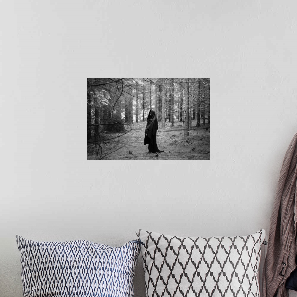 A bohemian room featuring Young adult female wearing veil standing alone in dark forest in winter