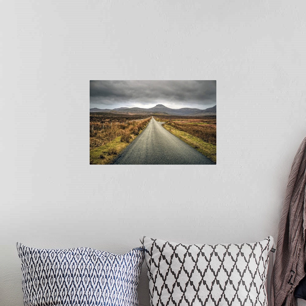 A bohemian room featuring Long straight road towards distant hills in Scotland, UK.