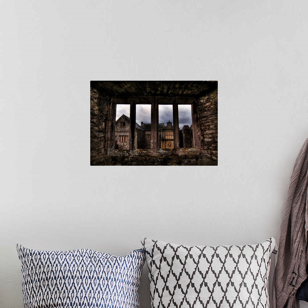 A bohemian room featuring View through a stone window of ruined castle. Beaupre Castle medieval ruins in Wales.