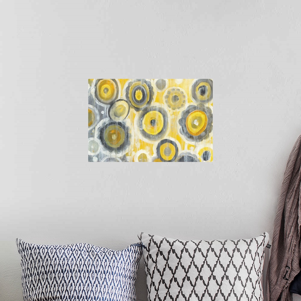 A bohemian room featuring Geometric abstract painting with yellow, gray, and white circles and white paint drips falling fr...