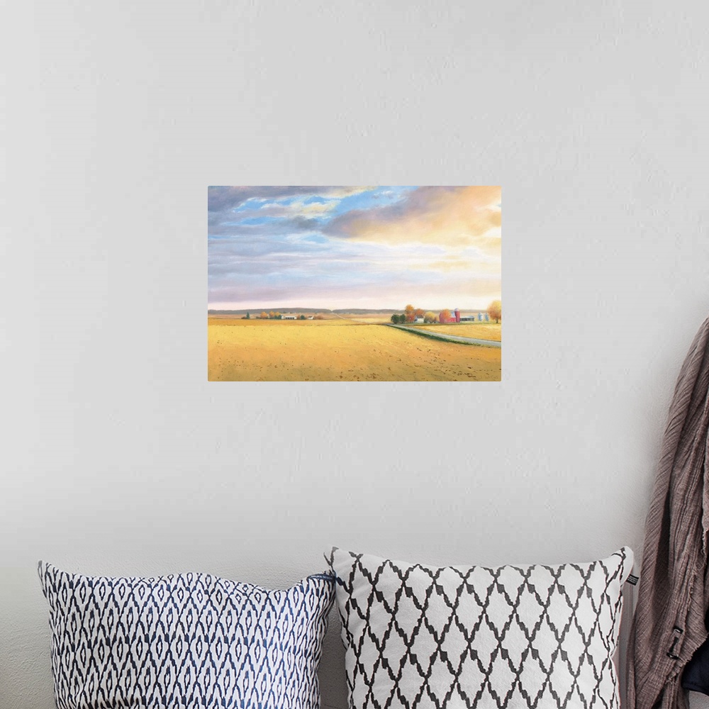 A bohemian room featuring Landscape painting of a rural area with golden fields and a road leading to the horizon.