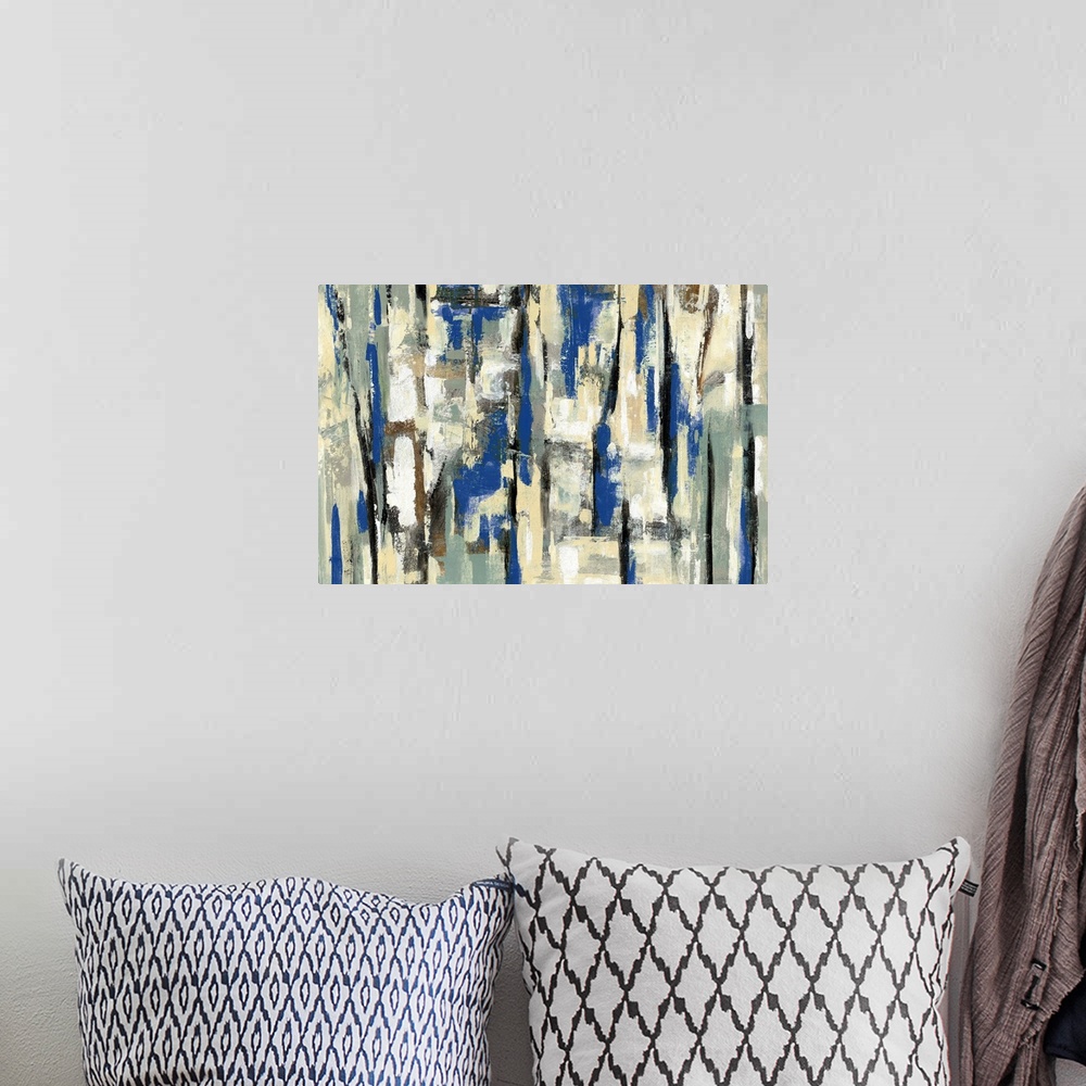 A bohemian room featuring Large abstract painting with layers of blue, tan, white, gold, and black hues.