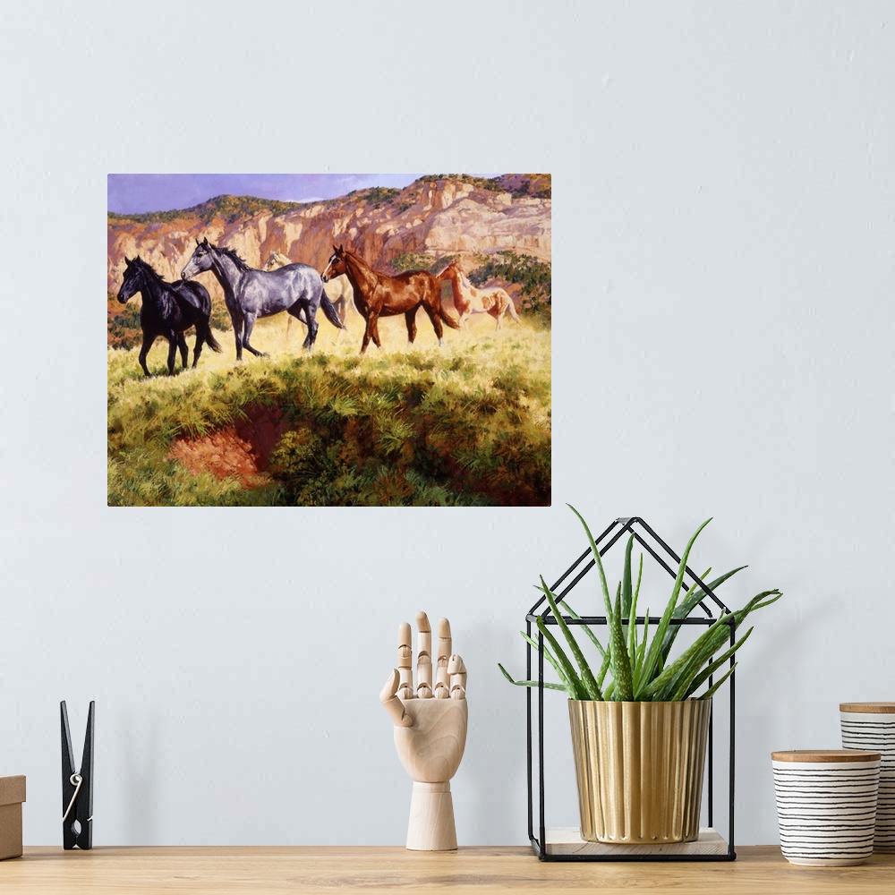 A bohemian room featuring Contemporary colorful painting of a herd of horses running through a desert landscape.