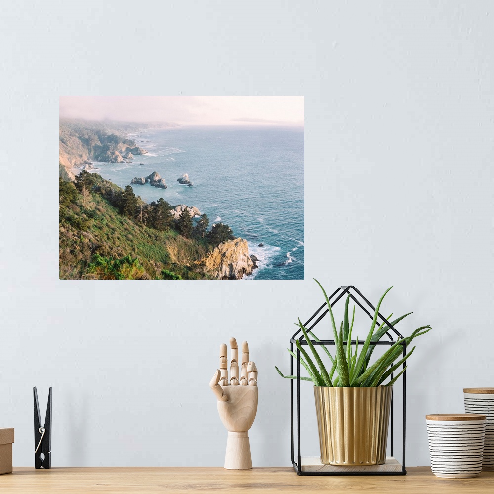 A bohemian room featuring A high angled photograph of the rocky cliffs of Big Sur, California.