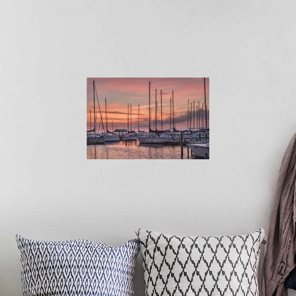 A bohemian room featuring A serene photo featuring sailboats huddled in a marina while the sun rises in the background