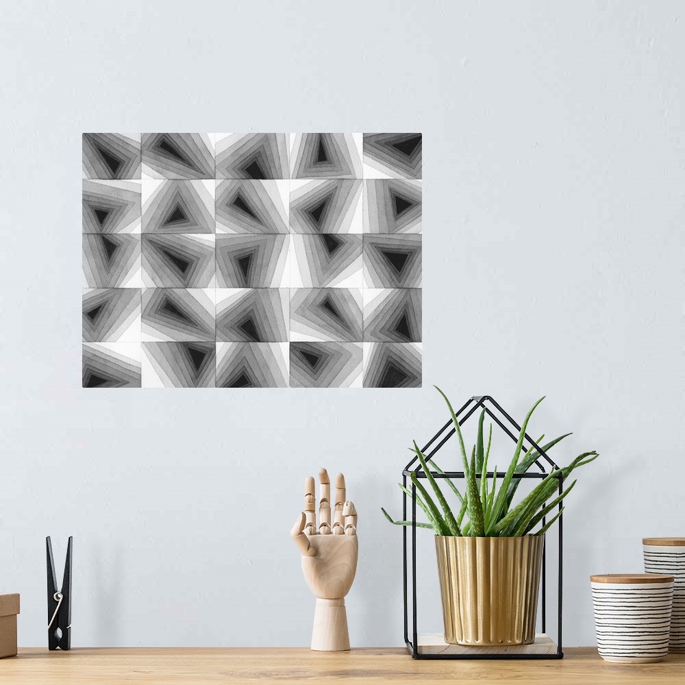 A bohemian room featuring Contemporary abstract artwork of a grid of geometric shapes in gradating gray tones.