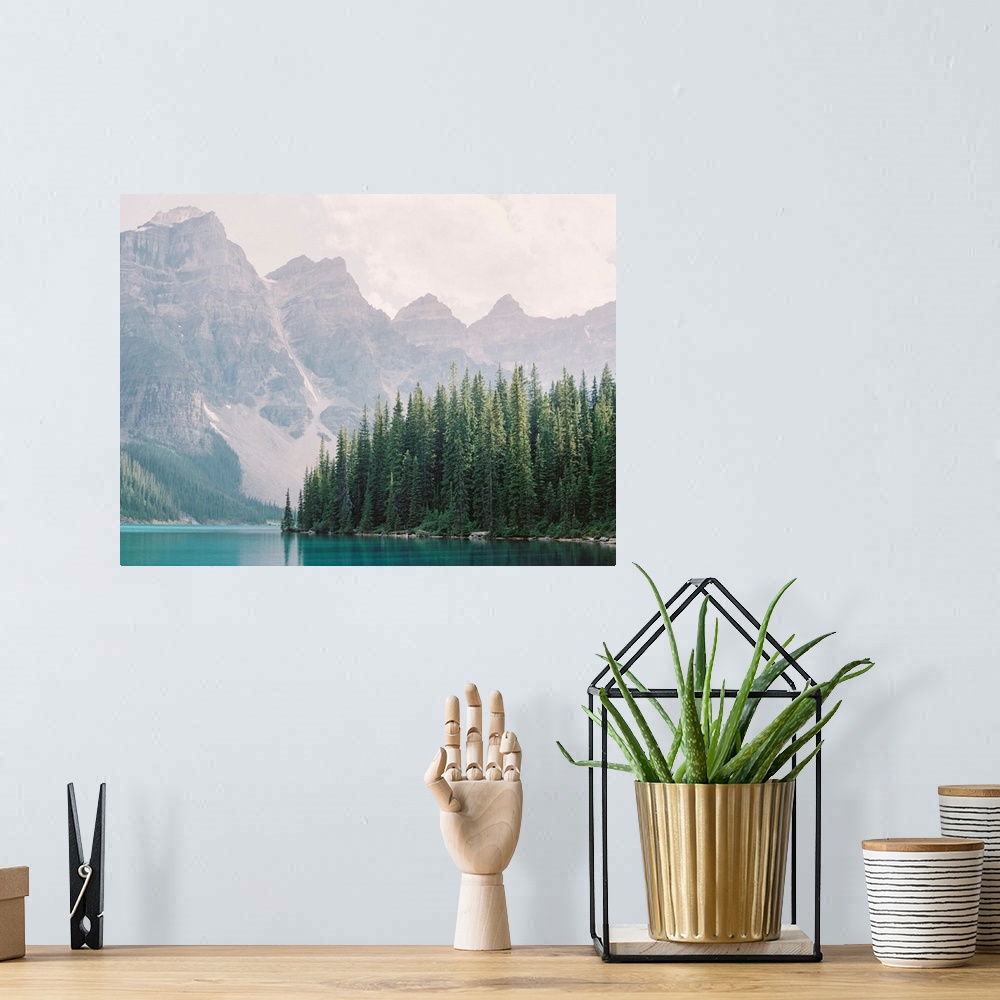 A bohemian room featuring Photograph of tall evergreen trees at the edge of a clear blue lake, Moraine Lake, Banff national...
