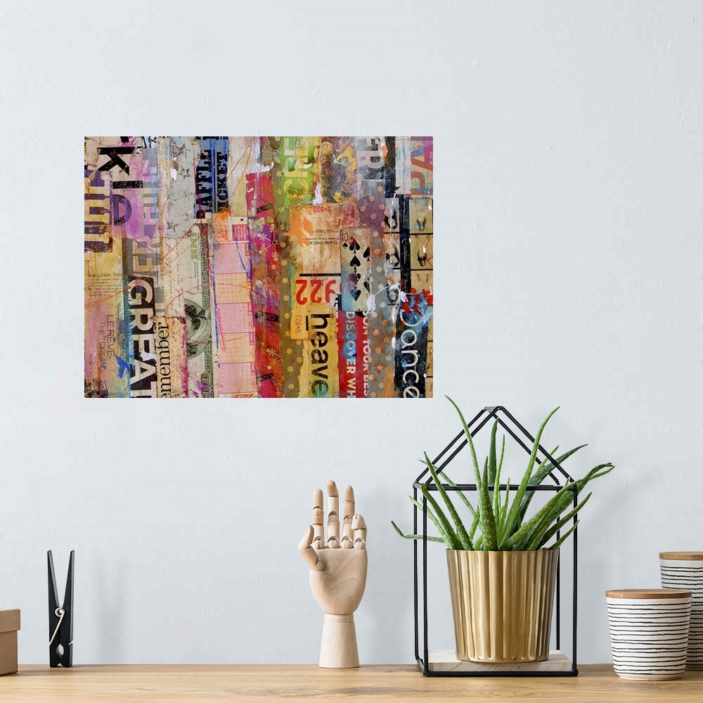 A bohemian room featuring Contemporary mixed media artwork composed of a variety of found text arranged vertically.