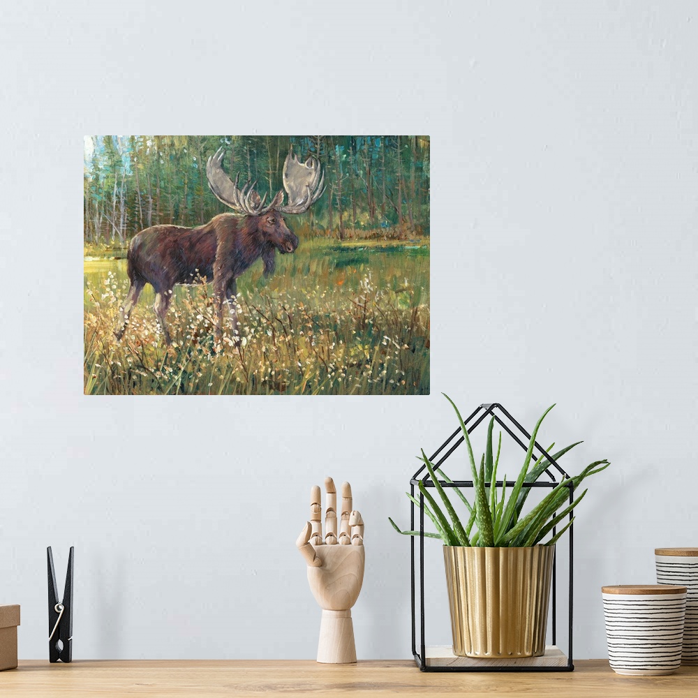 A bohemian room featuring Contemporary painting of a moose standing in a meadow near a forest.