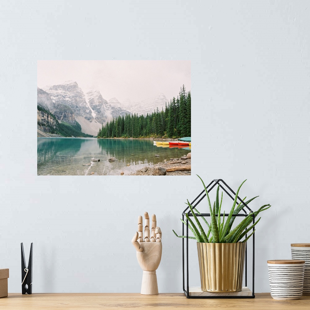 A bohemian room featuring A horizontal photograph of the mountains and trees reflected in Moraine Lake, Banff national park...