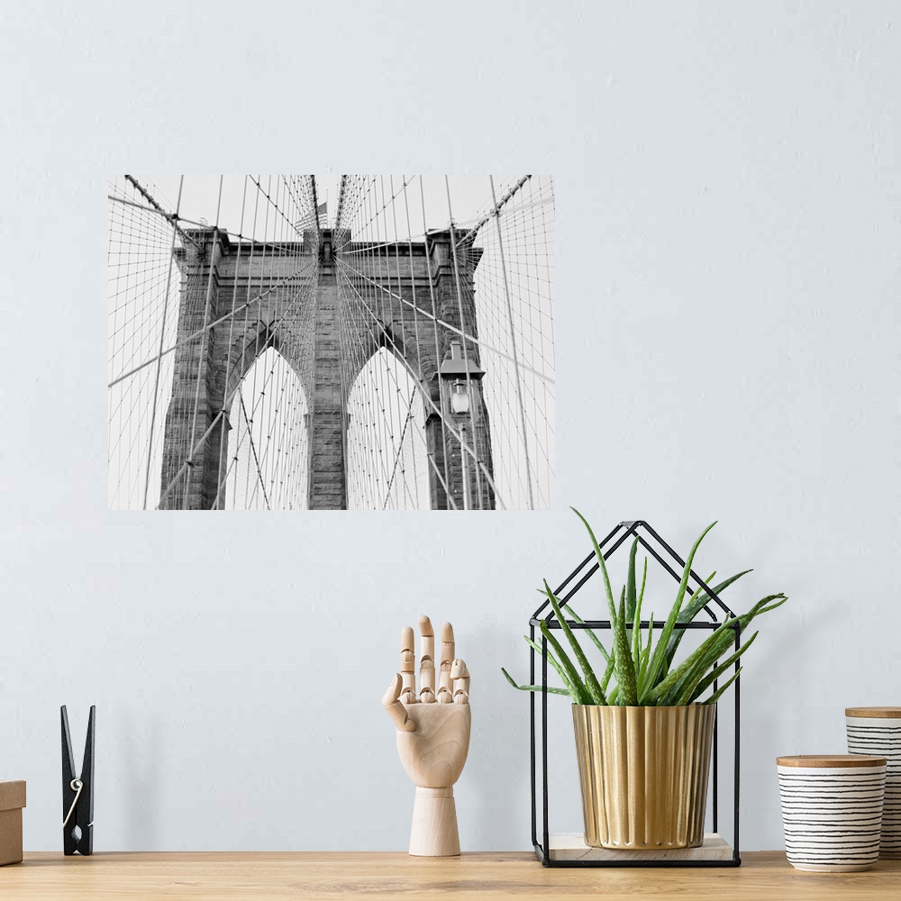 A bohemian room featuring Black and White architectural photograph of New York's Brooklyn Bridge.