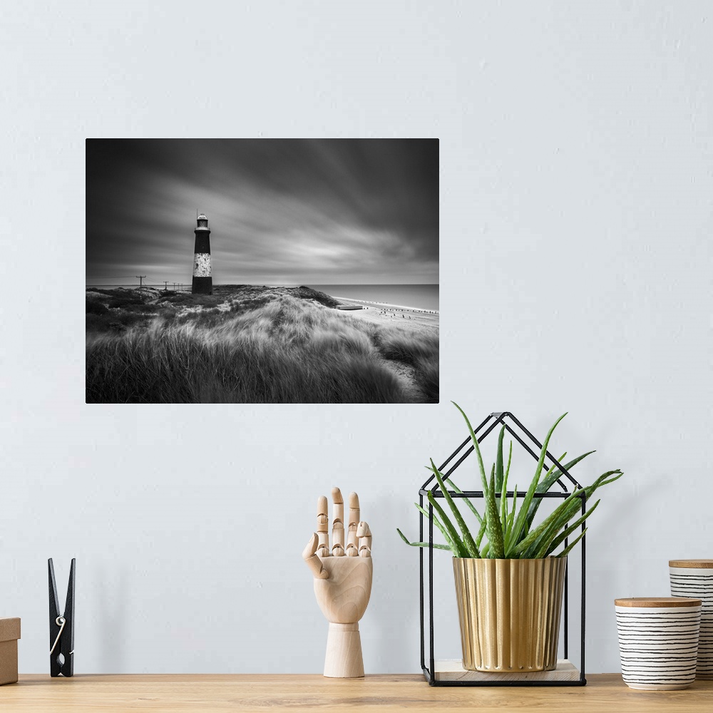 A bohemian room featuring Fine art photo of a striped lighthouse on the coast near grassy dunes.