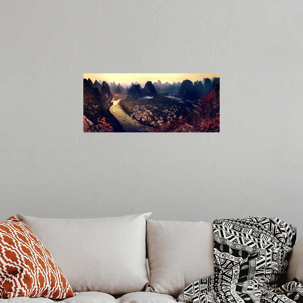 A bohemian room featuring A dynamic and intense photograph of a view of the Karst mountains in Guangxi, China.
