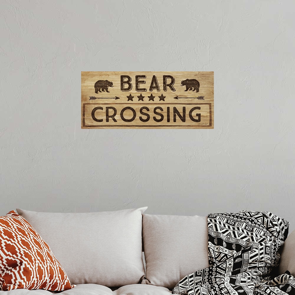 A bohemian room featuring Contemporary cabin decor artwork of a wooden sign for Bear Crossing.