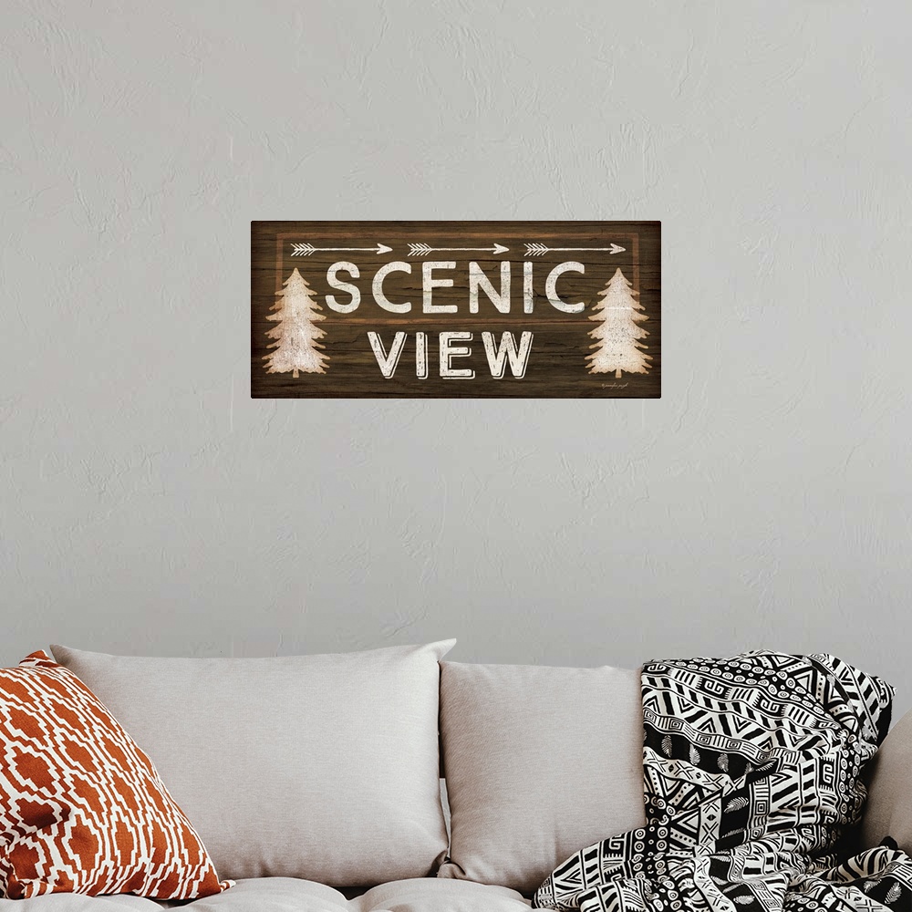 A bohemian room featuring Contemporary cabin decor artwork of a wooden sign for Scenic View.
