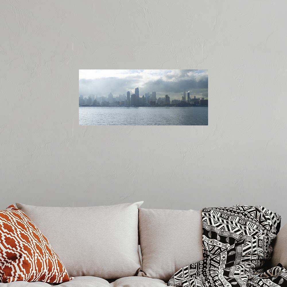 A bohemian room featuring Sun breaking through clouds over midtown Manhattan