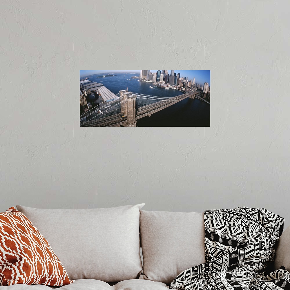 A bohemian room featuring Panorama of the Brooklyn Bridge, skyscrapers and boats in the East River of New York City.