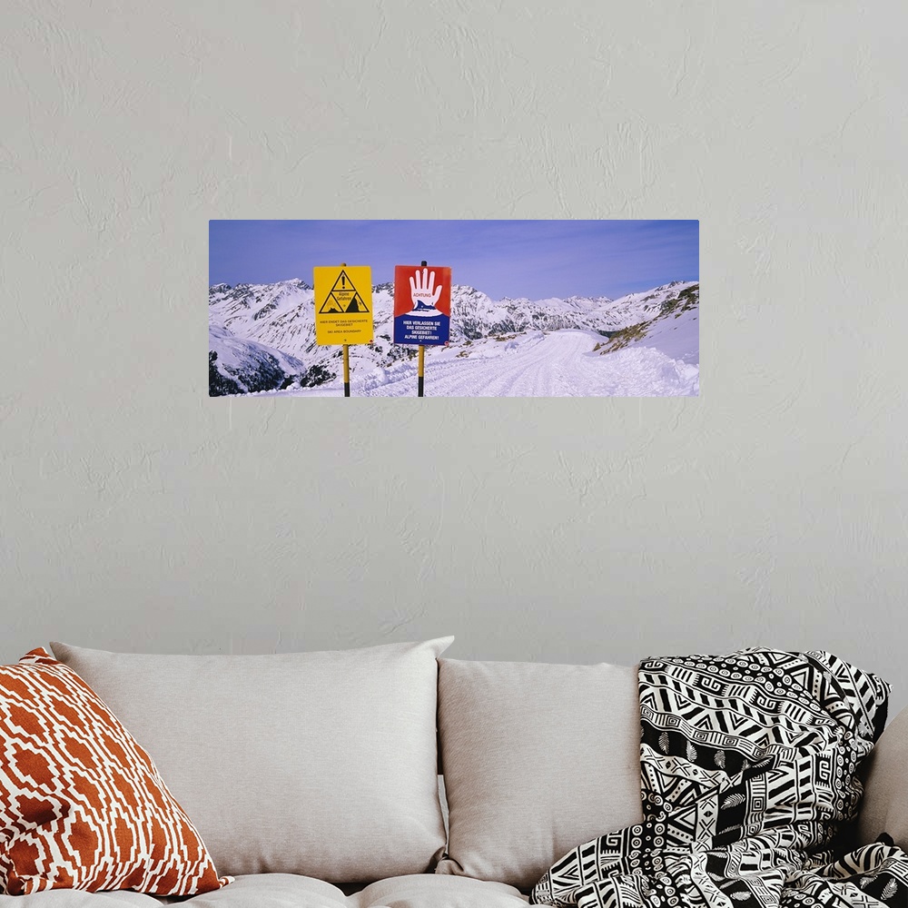 A bohemian room featuring Avalanche warning signs on snowcapped mountains, Rendl Ski Area, St. Anton, Austria