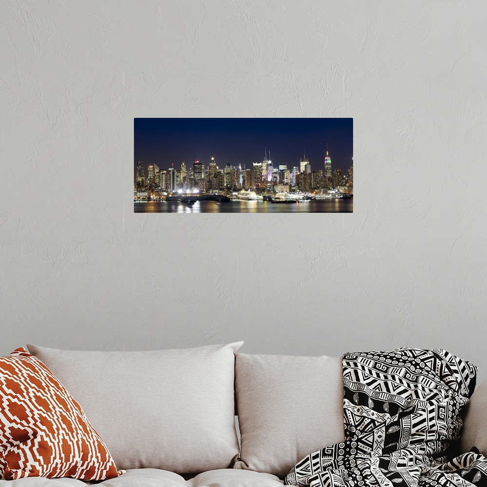 A bohemian room featuring Panoramic photograph showcases a busy skyline filled with skyscrapers as they shine brightly in t...