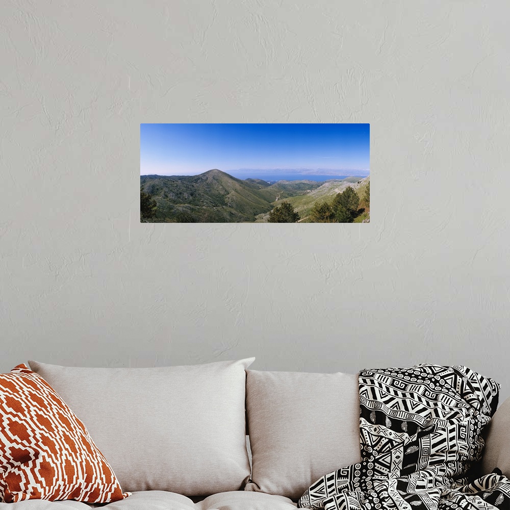A bohemian room featuring Mountain range with a sea in the background, Corfu, Ionian Islands, Greece