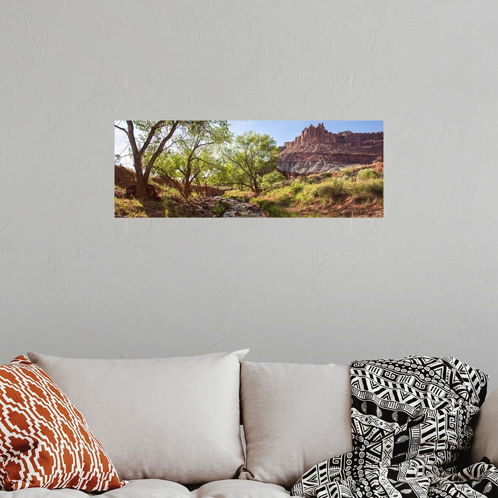 A bohemian room featuring View of 'The Castle' rock formation near a stream at Capitol Reef National Park.