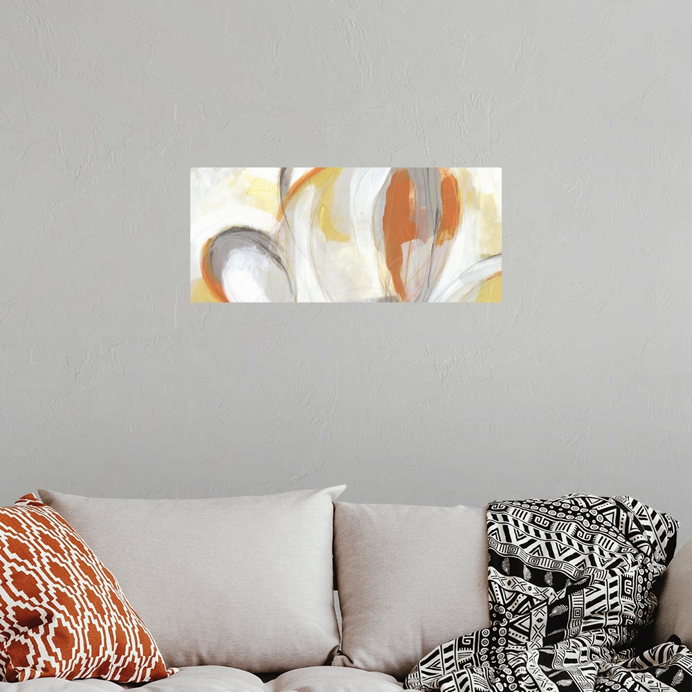 A bohemian room featuring Abstract artwork in large oval shapes in orange, yellow and white.