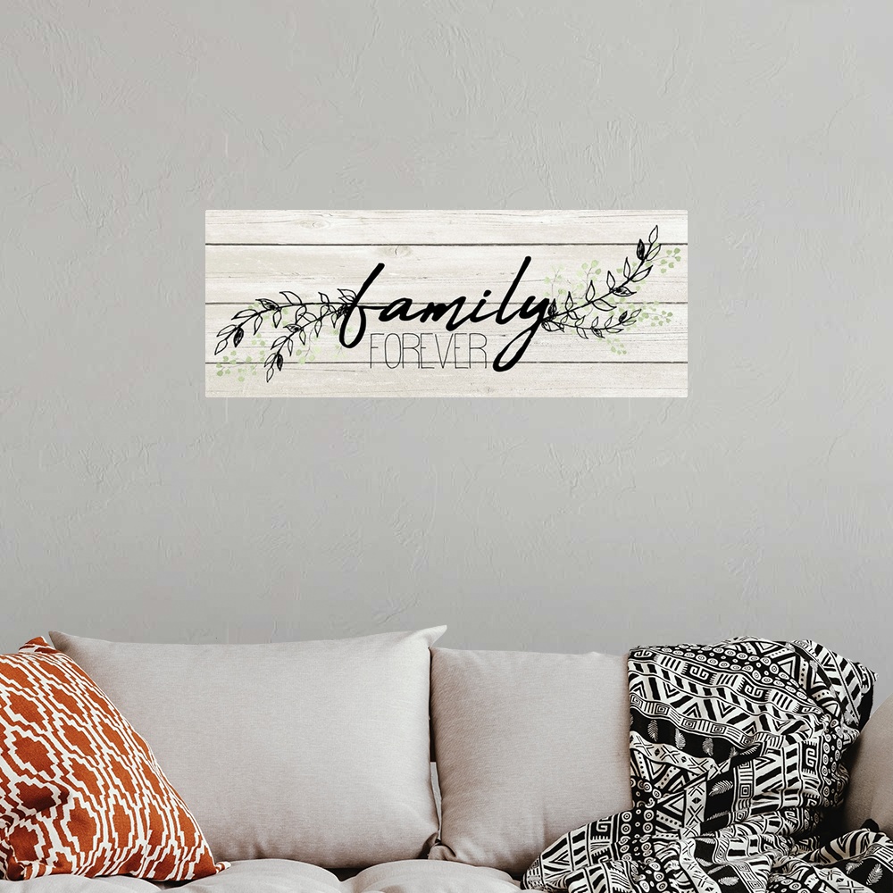 A bohemian room featuring "Family Forever" with a branches of leaves on a white wood plank background.