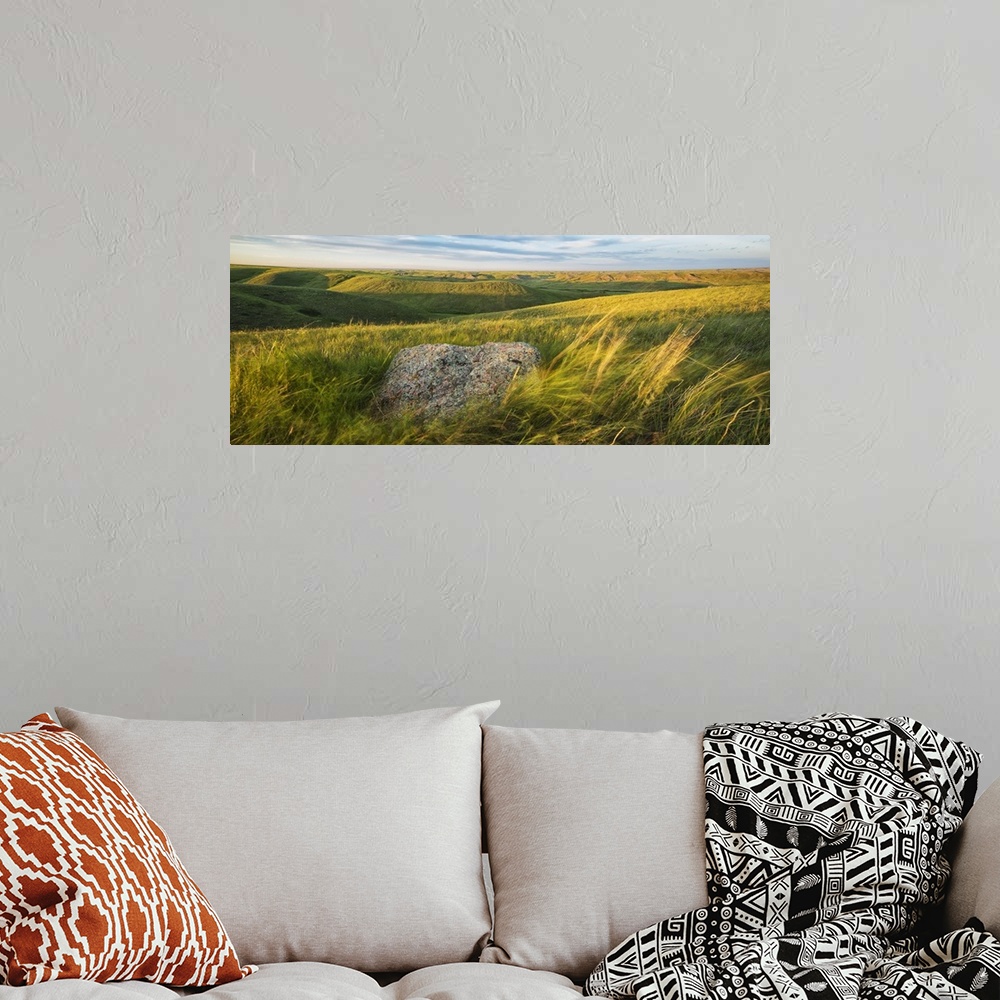 A bohemian room featuring Sunset Over The Coulees And Buttes Of Grasslands National Park With Erratic In Foreground; Saskat...