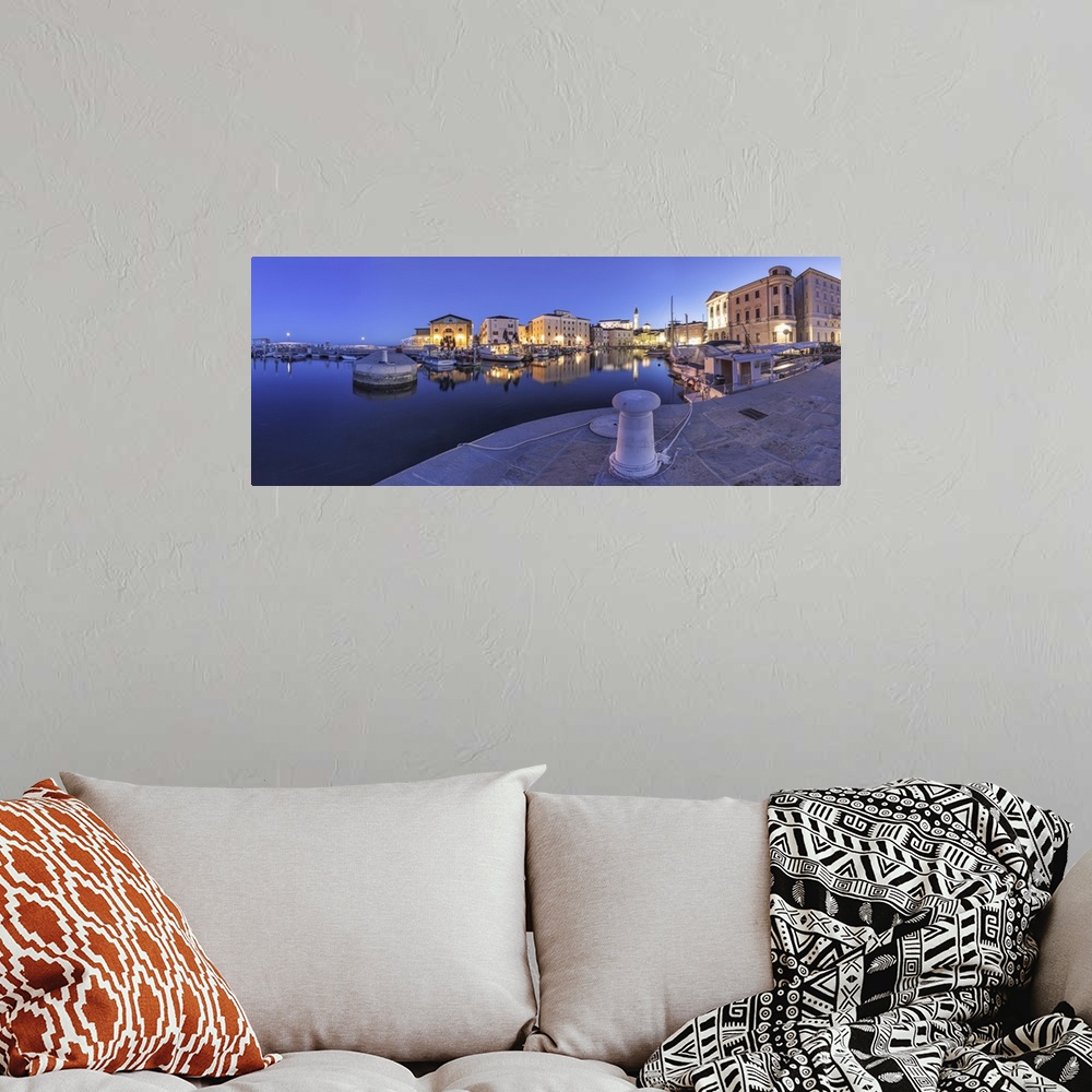 A bohemian room featuring Europe, Slovenia, Istria, Piran. The picturesque port and the buildings around it at dusk