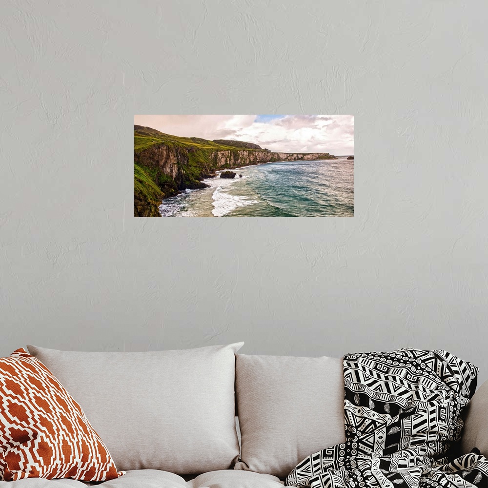 A bohemian room featuring Panoramic photograph of the picturesque Cliffs of Moher with a cloudy sky above, located at the s...