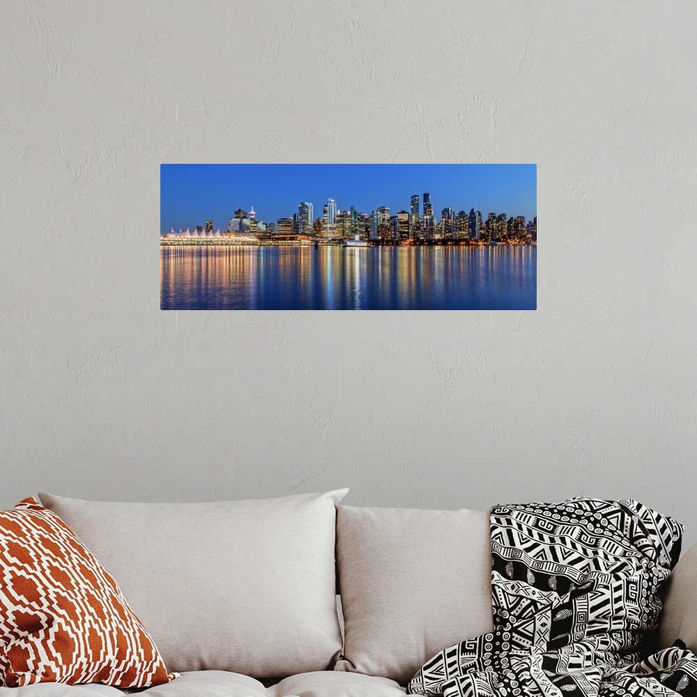 A bohemian room featuring Photograph of the downtown Vancouver skyline lit up at dusk and reflecting onto the water creatin...