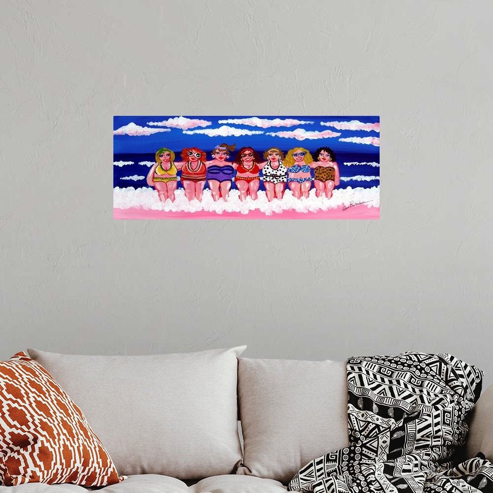 A bohemian room featuring A group of women are enjoying themselves in the surf and sand, under blue skies, at the beach.