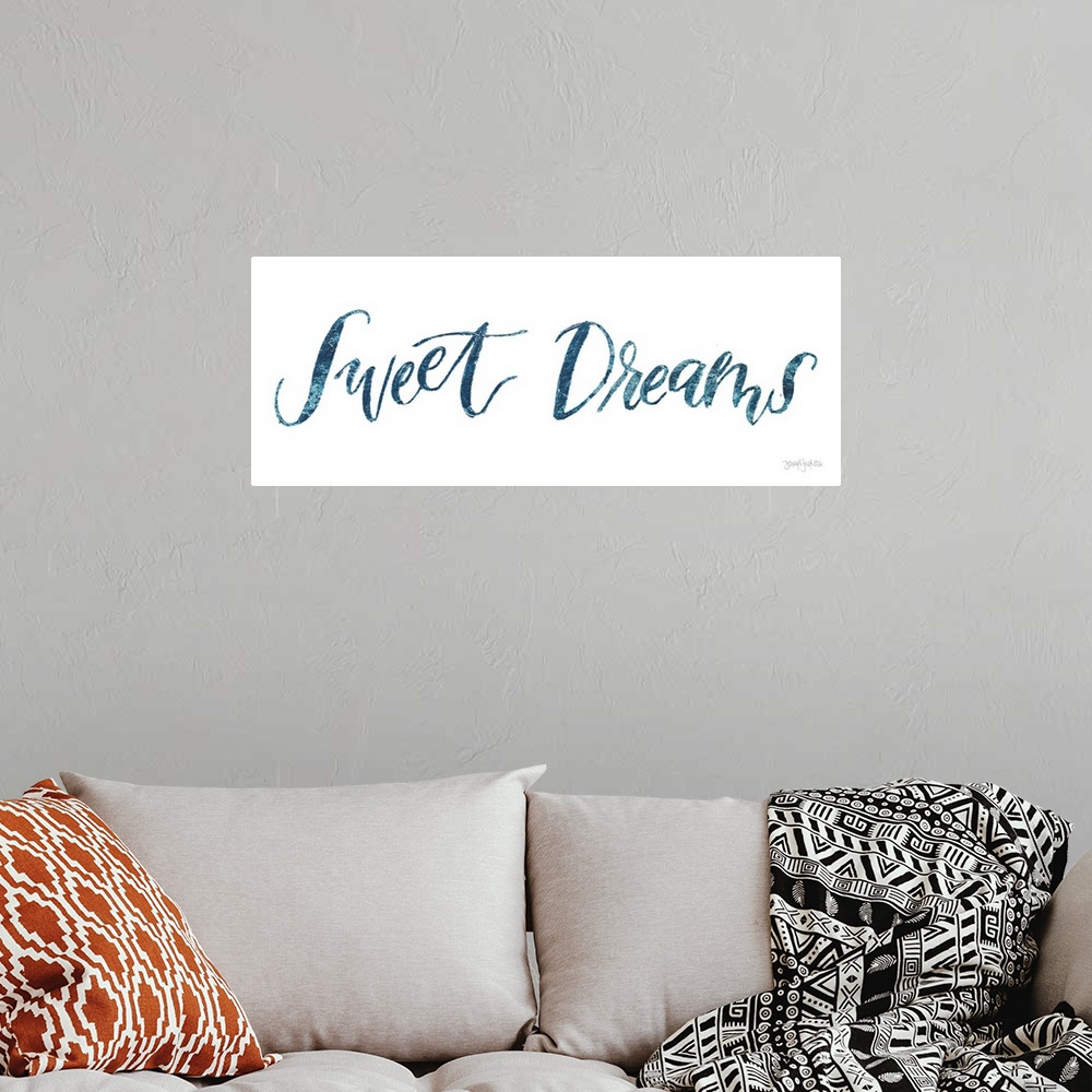 A bohemian room featuring "Sweet Dreams" handwritten in blue on a white background.