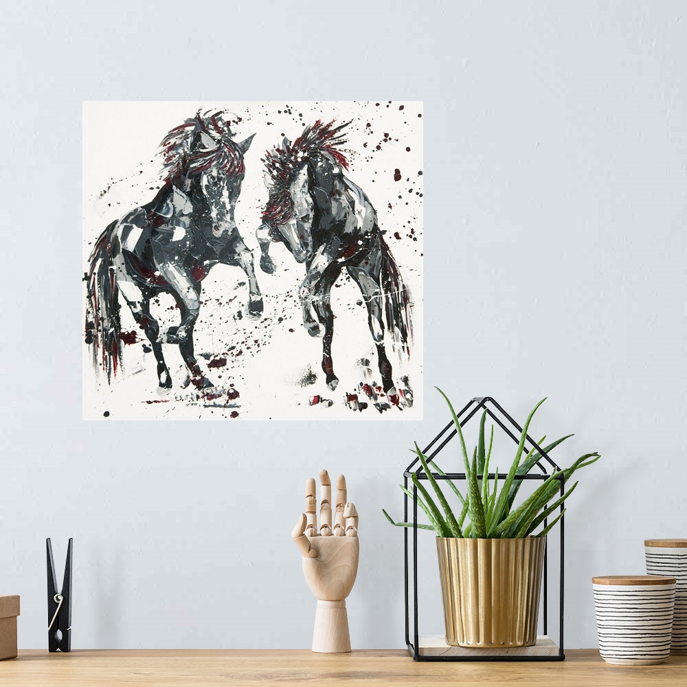 A bohemian room featuring Contemporary painting of two leaping horses in shades of black with red.