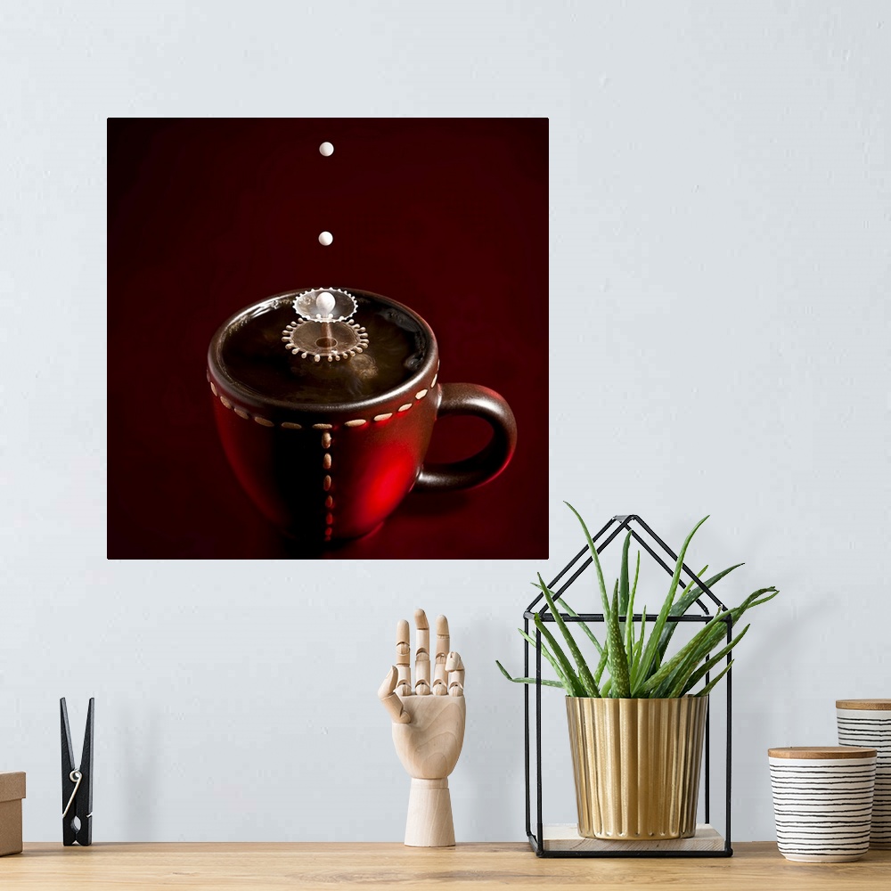 A bohemian room featuring Conceptual image of droplets of milk splashing into coffee in a mug, creating abstract patterns.