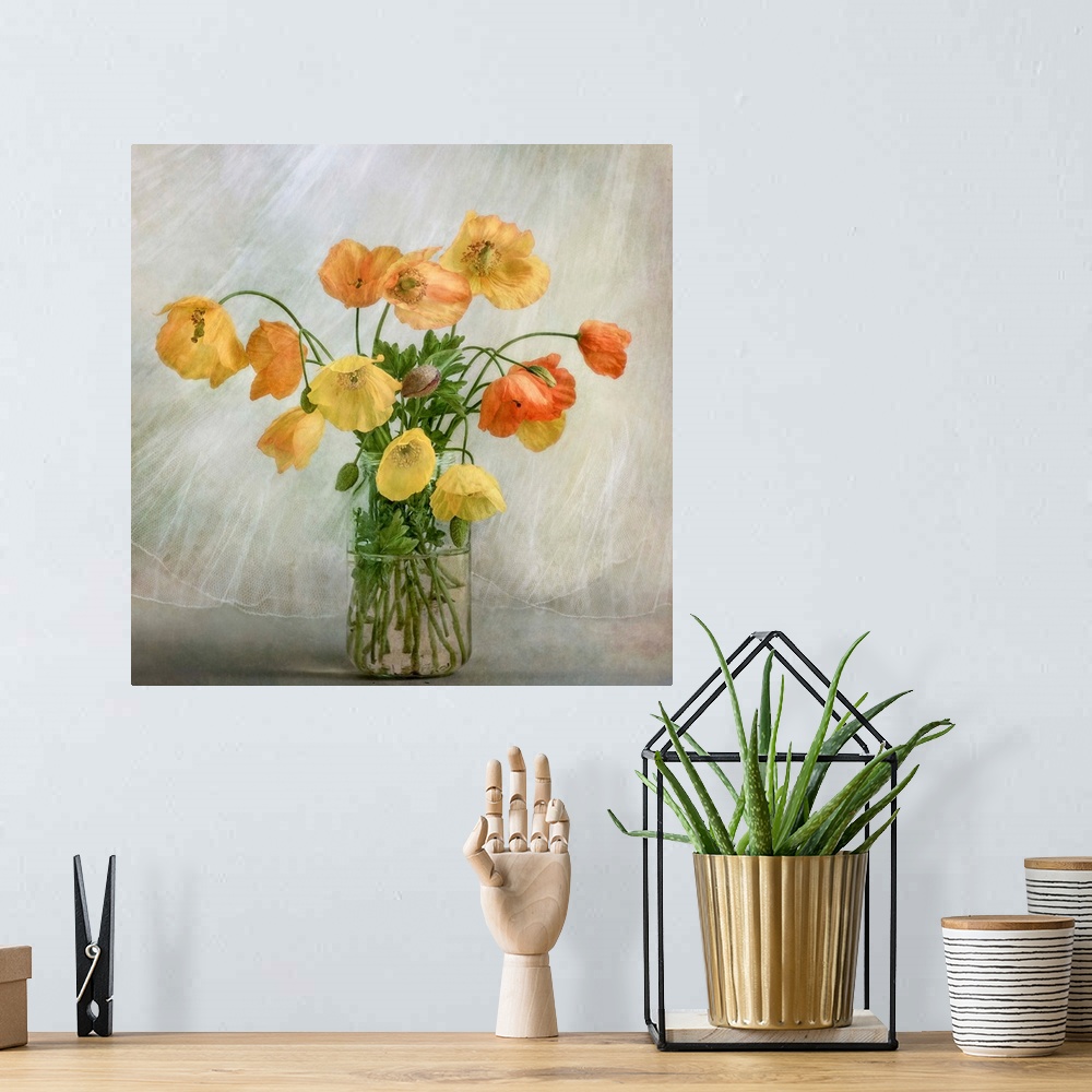A bohemian room featuring A glass jar full of yellow and orange poppies.