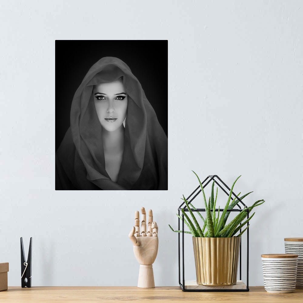 A bohemian room featuring Black and white portrait of a beautiful woman wearing a veil.