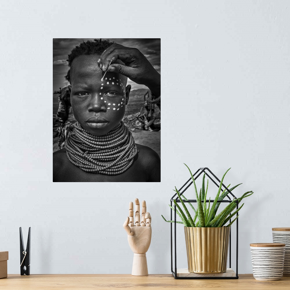A bohemian room featuring Painting The Face Of A Karo Tribe Girl (Omo Valley-Ethiopia)