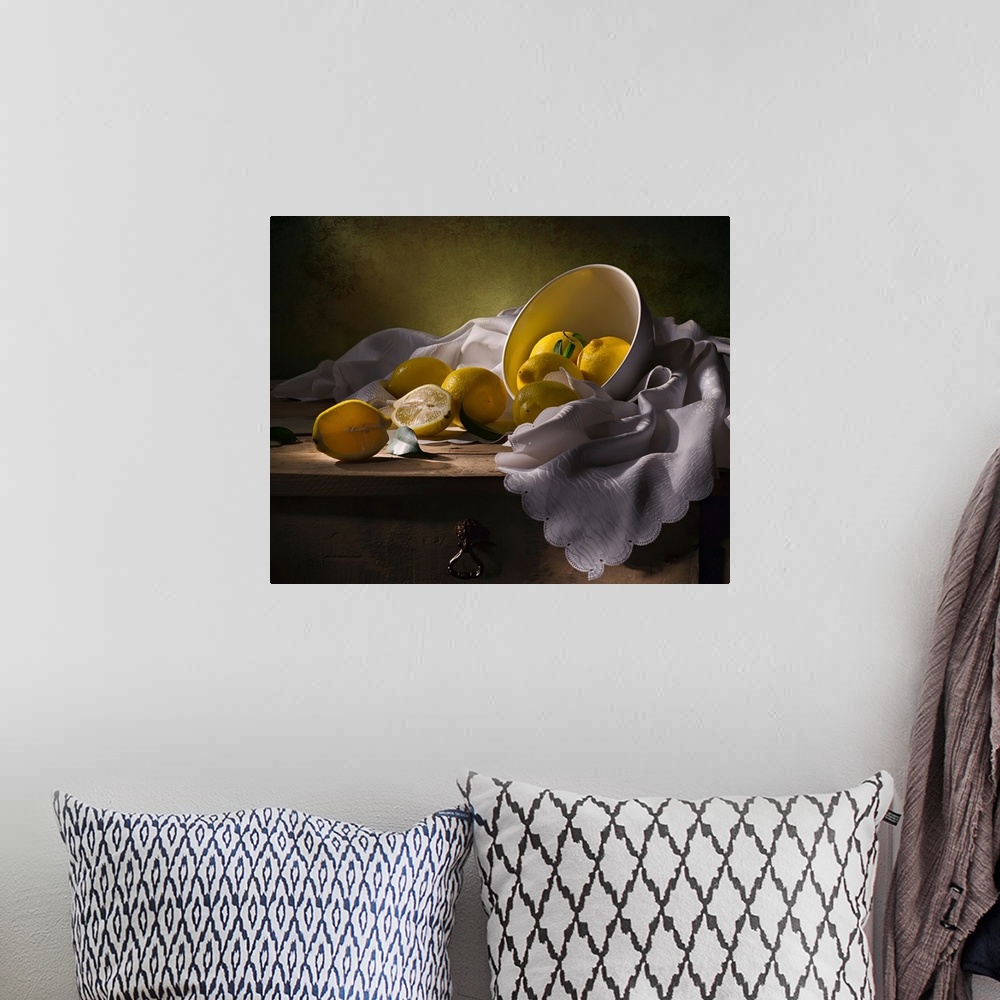 A bohemian room featuring A bowl of lemons on a white cloth, one split in half.