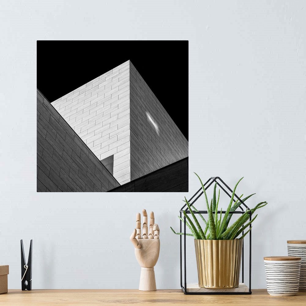 A bohemian room featuring Black and white image of triangular shadows created by a modern building.