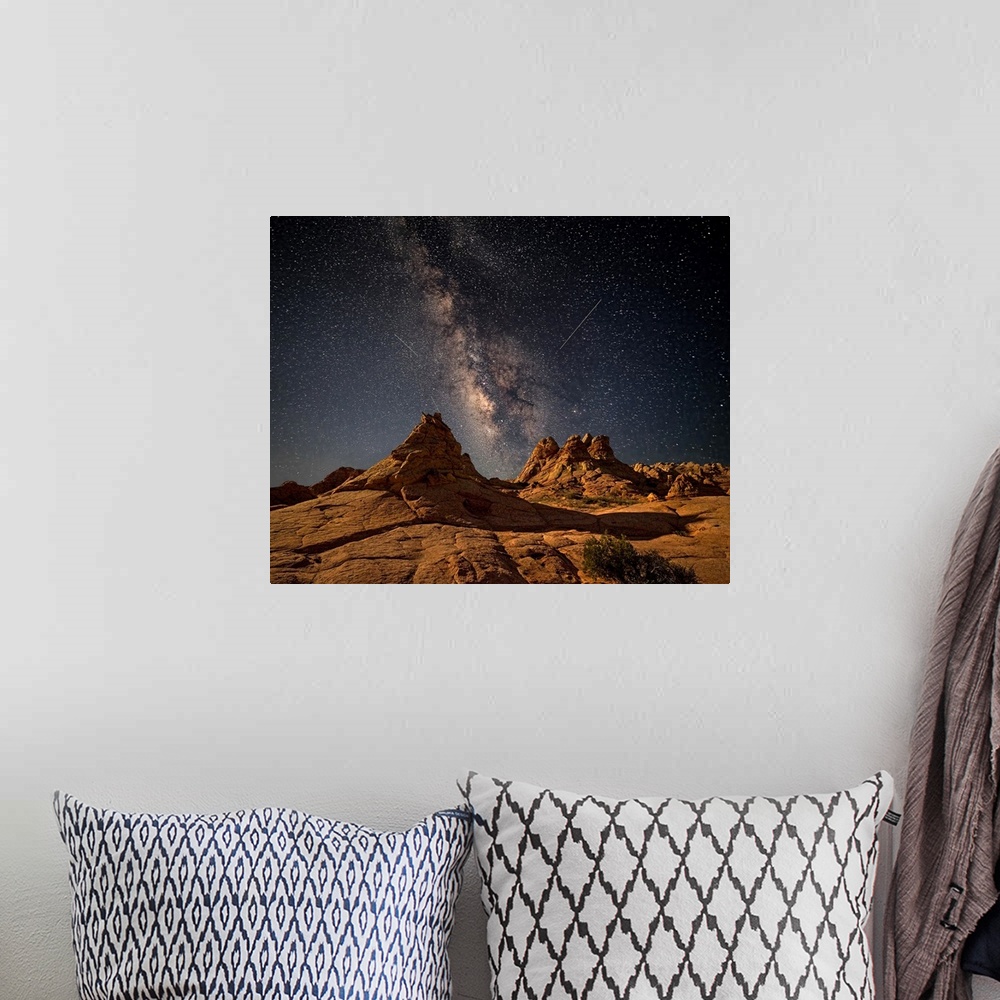 A bohemian room featuring Rock formations in the desert of Coyote Buttes, Arizona, under a starry night sky.