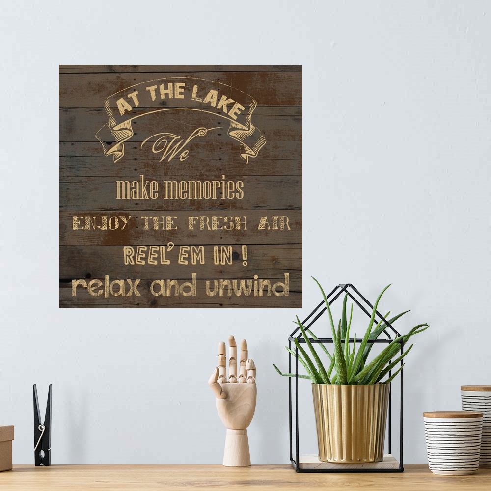 A bohemian room featuring "At the Lake We Make Memories Enjoy the Fresh Air Reel 'em in! Relax and Unwind" on an aged wood ...