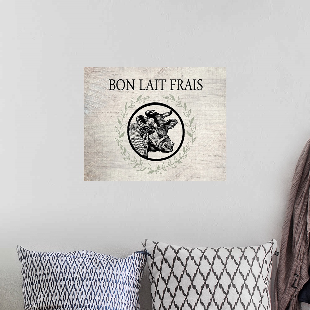 A bohemian room featuring "Bon Lait Frais" with a cow surrounded by a wreath on a wood textured background.