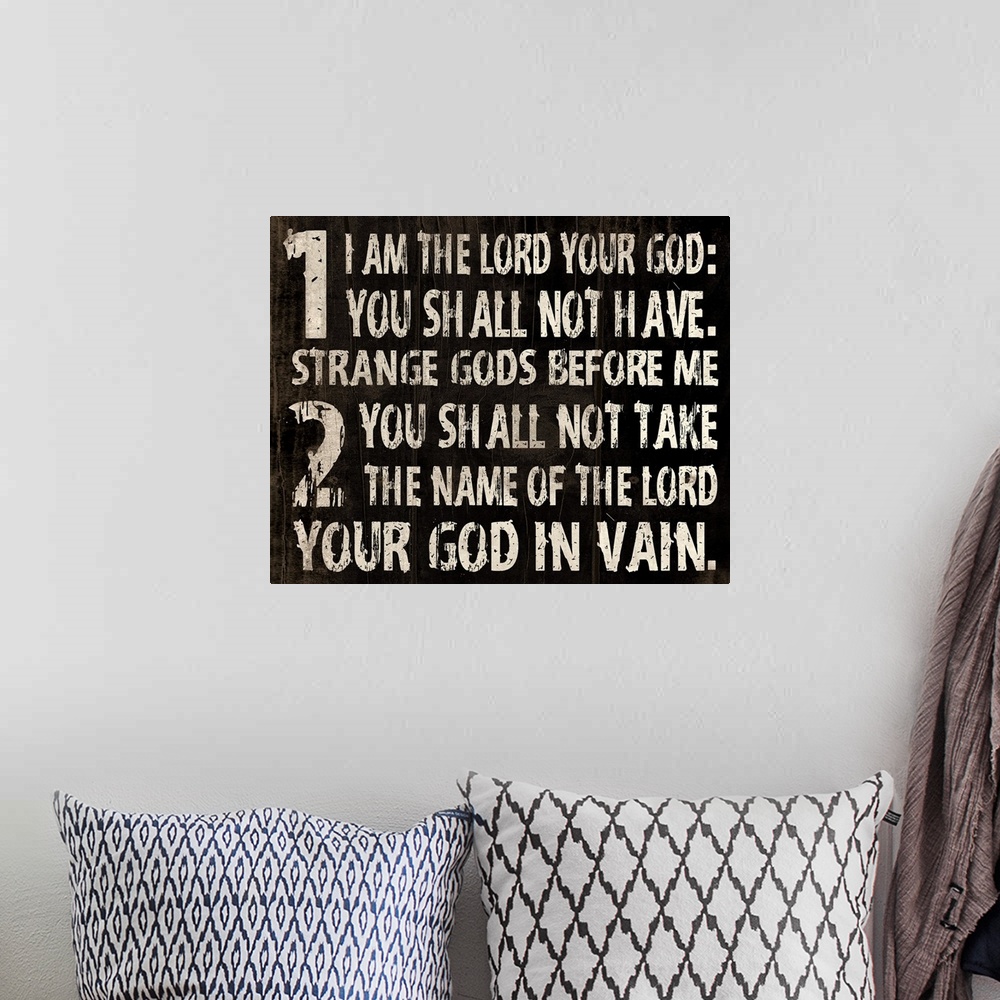 A bohemian room featuring Religious typography art, with the first two commandments in a weathered, rustic look.