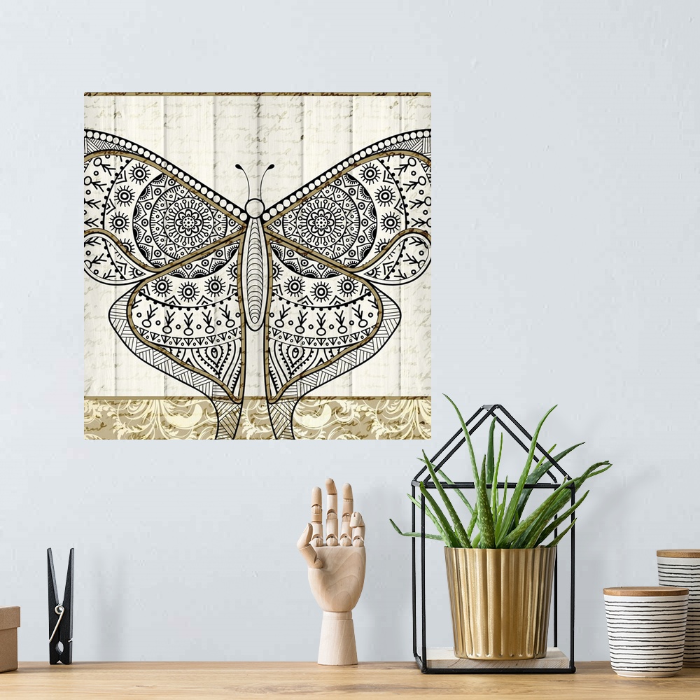 A bohemian room featuring A black and gold symmetrically designed butterfly on a white wood panel background with faint han...