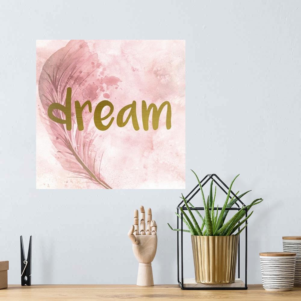 A bohemian room featuring A pink watercolor painting of a feather with the word ?dream? placed on top in gold text.�