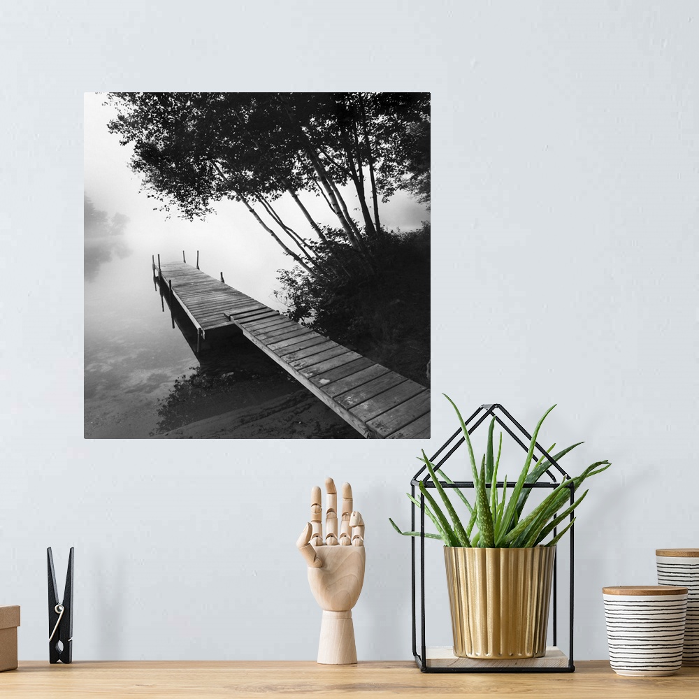 A bohemian room featuring Black and white photograph of a dock jetting out over a foggy lake in the countryside.
