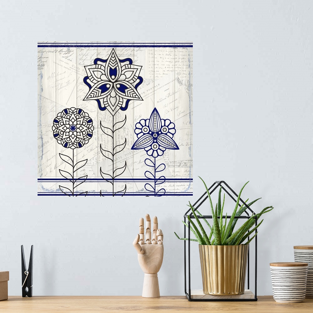 A bohemian room featuring A black and blue symmetric design of three flowers with a collage of handwritten postcards in the...