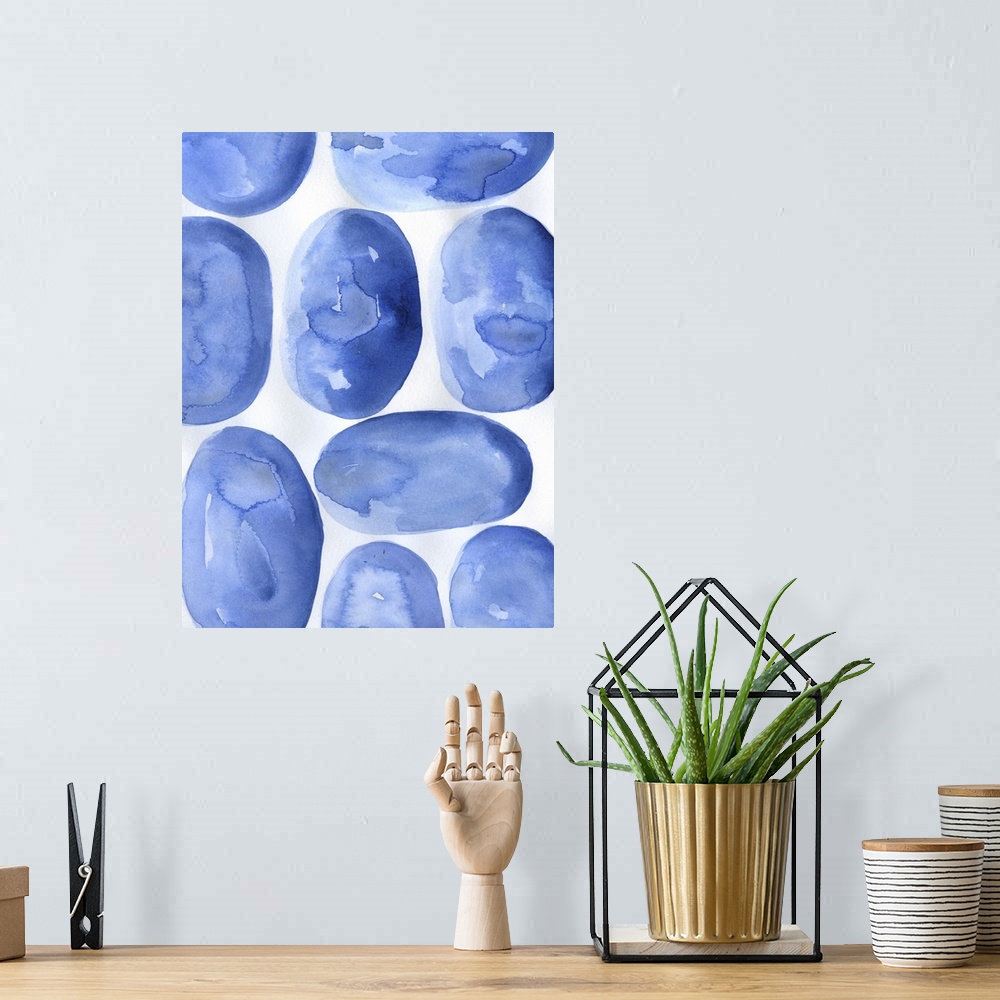 A bohemian room featuring Abstract artwork of round, blue shapes on white.